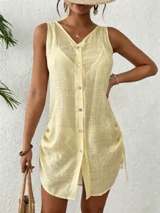 Detail view of light yellow sleeveless button-down beach cover-up with drawstring sides.