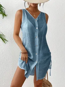 Detail of light blue sleeveless summer cover-up with drawstring and button front
