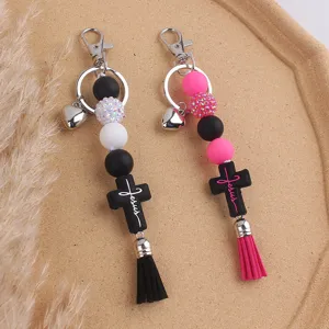 Creative silicone beaded keychain with cross and tassel, stylish bag charm and keyring accessory.