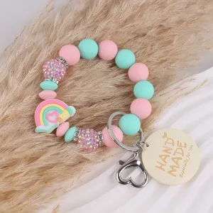 Handmade silicone bead keychain with rainbow charm and wooden tag for women and girls bag.