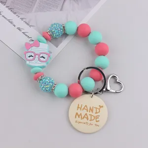 Colorful silicone bead wristlet keychain with cute cartoon charm and handmade wooden tag pendant.