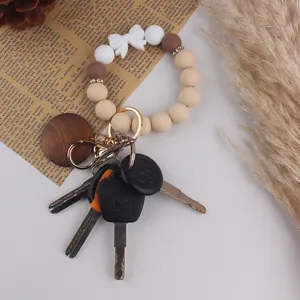 Silicone bead wristlet keychain with white bow and wooden charm for daily use