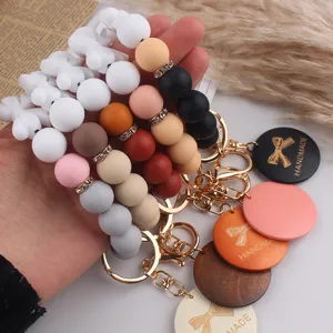 Silicone bead wristlet keychain with bow wooden pendant, handmade gift for Mother's Day.