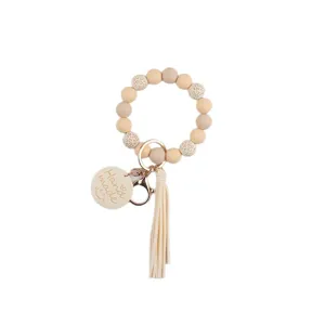 Bracelet porte-clés en perles de silicone avec pompon et pendentif fait main pour femmes.