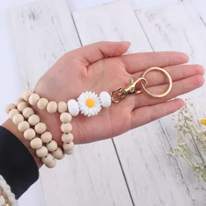 Holzperlen Schlüsselanhänger mit süßer Silikon Gänseblümchen Blume, modisches Armband für Damen.