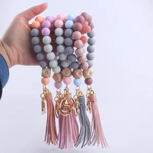 Colorful silicone beaded wristlet keychain with wooden evil eye charm and cute leather tassel.