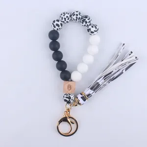 Silicone Beaded Wristlet Keychain with Cow Print Beads and Leather Tassel Detail