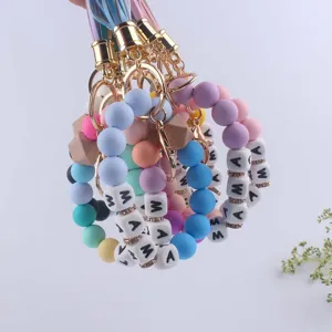 Silicone bead keychain bracelet with MAMA letter charms, wooden beads, and chic leather tassel.