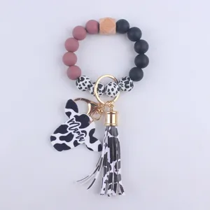 Silicone bead keychain with cow print, wooden bead, cow head pendant and tassel charm.