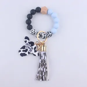 Detail shot of the silicone bead wristlet keychain with cow head charm and tassel.