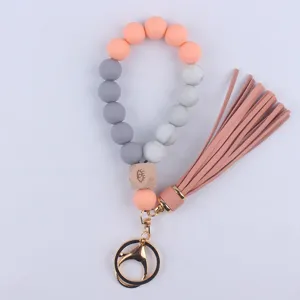 Silicone beaded wristlet keychain with leather tassel and eye wooden charm for keys.