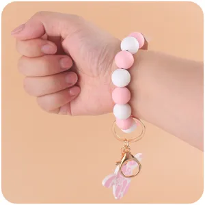 Silicone bead wristlet keychain with pink white round beads and cute cartoon cow head pendant.