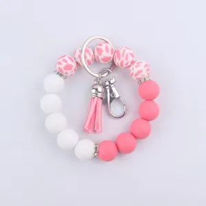 Porte-clés bracelet en perles de silicone avec gland vue détaillée et fermoir élégant.