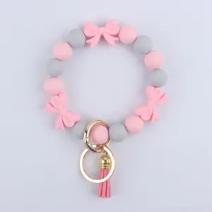 Bracciale portachiavi in perline di silicone con fiocchi graziosi e nappina in metallo donna.