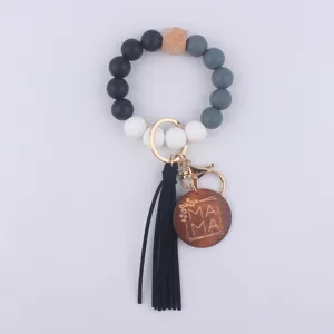 Silicone beaded wristband keychain with wooden pendant leather tassel for women daily use.