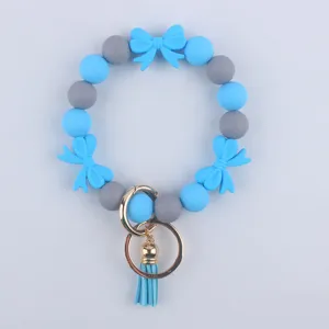 Bracciale portachiavi di perle di silicone con fiocchi blu e nappa per donne e ragazze.