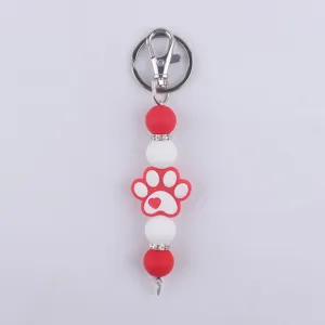 Lindo llavero de pata de perro de silicona rojo blanco cuentas cierre metal bolso