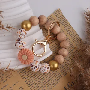 Holz und Silikon Perlen Armband Schlüsselanhänger mit süßem Gänseblümchen Anhänger für Taschen.