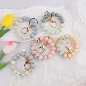 Silicone beaded keychain wristlet bracelet with floral pattern and metal clasp for keys bag.