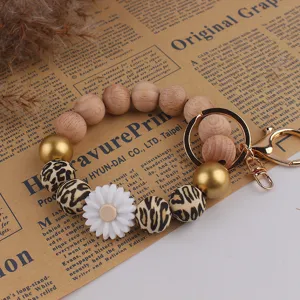 Gänseblümchen Silikonperlen Armband Schlüsselanhänger mit Holz und Leopardenperlen Gold.