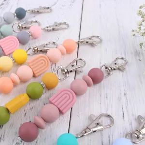 Silicone beaded keychain detail, colorful pastel rainbow beads and metal clasp for DIY accessories.
