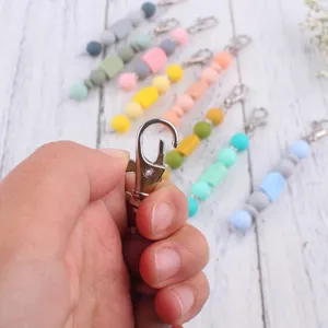 Silicone beaded keychain clasp detail, colorful DIY accessory hardware close up shot