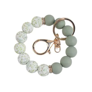 Silicone bead wristlet keychain with leaf pattern and gold metal clasp for women main.