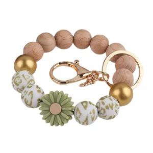 Armband Schluesselanhaenger mit Holzperlen Silikonperlen und goldener Bluete fuer Damen.