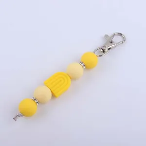 Detailed view of DIY silicone bead keychain charm with colorful rainbow pendant and rhinestones.