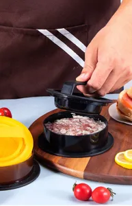 Macro detail of manual hamburger patty press making a round meat burger on a wooden board