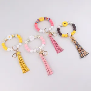 Silikon Perlen Schlüsselanhänger Armband mit süßen Gänseblümchen Blumen und Leder Quasten.
