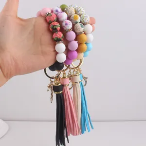 Pulsera llavero de cuentas de silicona con borla, detalles de muñeca estampados coloridos.