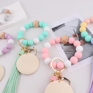 Colorful silicone bead wristlet keychain with wooden charm and leather tassel for women.