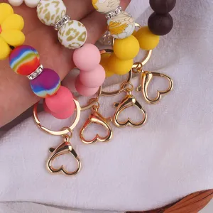 Close-up detail of colorful silicone beaded keychain bracelets with cute flower and heart clasps.