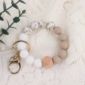 Silicone beaded wrist keychain with beech wood octagonal bead and gold metal clasp for women