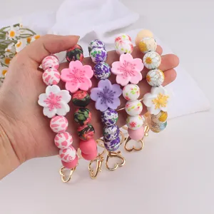 Silicone beaded keychain detail showing cherry blossom flowers and cute floral printed beads.