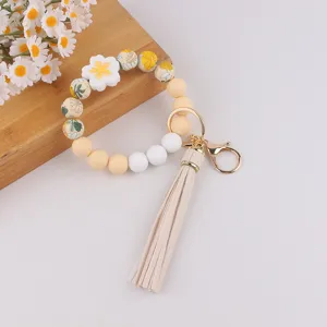 Silikon Perlen Schlüsselanhänger Armband mit Gänseblümchen Blume und Quaste für Damen Schlüssel.