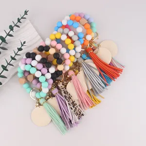 Silicone beaded keychain detail showing colorful wristlets with wooden beads and tassels.