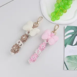 Handmade macrame bow phone charm detail, cute floral braided keychain pendant for bags.