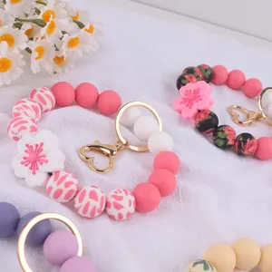 Silicone beaded keychain detail view, floral charm bangle bracelet accessory, cute colorful style.
