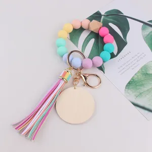 Colorful silicone bead keychain wristlet with leather tassel and wooden charm for daily use.