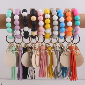Colorful silicone bead keychains with tassels and wooden discs for women daily wrist wear.