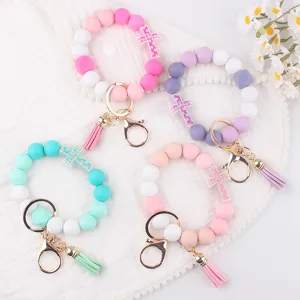 Silicone beaded keychain detail, colorful silicone wristlet bracelet with cross pendant.