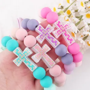 Colorful silicone beaded bracelets with daisy cross charms, perfect for daily accessory and DIY keychain use.