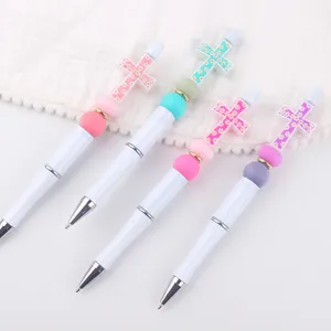 DIY beaded cross ballpoint pen detail view showing colorful silicone beads and cute charms.