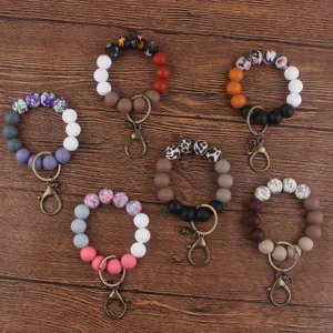 Silicone beaded wristlet keychain with colorful floral prints, fashionable and practical accessory.