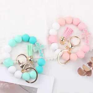 Silicone bead wristlet keychain with cross pendant and cute tassel. Perfect detail view.