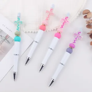 DIY beaded pen with colorful cross silicone beads, creative handmade ballpoint pen detail.