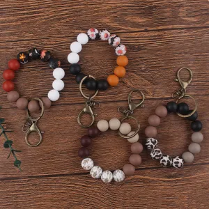 Silicone beaded wristlet keychain set featuring floral and leopard print design details.