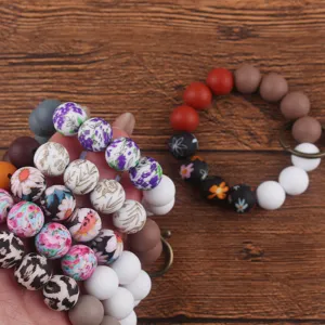 Silicone beaded wristlet keychain detail, colorful floral and leopard print key ring accessories.